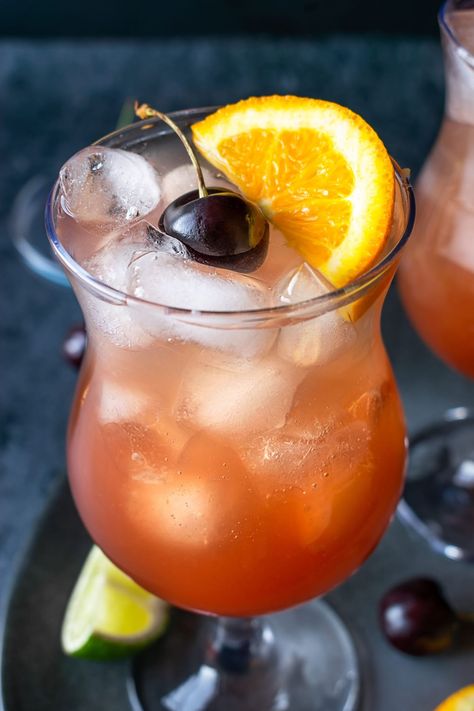 This Hurricane cocktail is a force to be reckoned with! It's fruity, boozy, and goes down dangerously easy. Make it in under 5 minutes, with just 8 ingredients. Boozy Drinks For A Crowd, Boat Drinks Alcohol Easy, Mixed Drinks Alcoholic Gallon, Big Batch Tiki Cocktails, Hurrican Cocktail Drinks, Orange Wheels, Passion Fruit Juice, Rum Punch, Light Rum