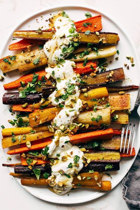 Roasted Carrots with Honey and Garlic Yogurt Sauce! These beauties need to be on your table! Deeply roasted rainbow carrots, swizzles of tangy garlicky yogurt sauce, a golden drizzle of honey, and festive pistachio crunches on top. #carrots #yogurt #sidedish Preprep Dinner, Roasted Carrots Yogurt Sauce, Carrots Asparagus Roasted, Roasted Carrots Salad, Roasted Veggies With Sauce, Roasted Vegetables With Sauce, Roasted Carrot Salad Recipes, Fall Roasted Carrots, Sauce For Carrots