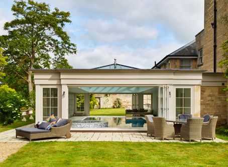 Pool house extension with doors open onto outside seating area Year Round Pool Enclosure, Pool Garden, Veranda Design, Westbury Gardens, Outside Seating Area, Indoor Pool Design, Piscina Interior, Pool Enclosures, Indoor Outdoor Pool