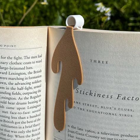 PRICES MAY VARY. ✔ Charming and Unique Design: The Spilled Coffee Bookmark features a cute and humorous design of spilled coffee on a page corner, adding a touch of whimsy to your reading routine. It's a conversation starter and a fun accessory for any book lover. ✔ High-Quality Materials: Crafted with durable materials, this bookmark is built to last through many reading sessions. The high-quality construction ensures that it securely holds your place in any book without adding bulk or weight. Coffee Bookmark, Reading Accessories, Bookmarks For Books, Spilled Coffee, Fine Writing Instruments, Coffee Cup Design, Creative Coffee, Sac Lunch, Cute Bookmarks