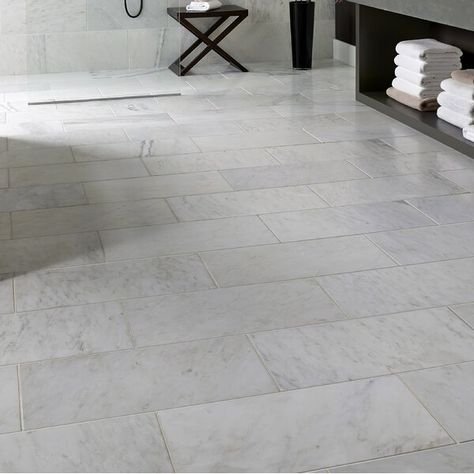 Install Carrara 12" x 24" Natural Stone Field Tile in Gray to incorporate a distinctive, contemporary aesthetic enhancement into kitchens, bathrooms and more. This tile combines a brilliant Gray color with distinct streaks of gray in a smooth finish to create a great complement to your decor. This tile is great for a wide variety of commercial and residential projects. With a large selection of sizes and accessories to choose from, this tile can easily be laid in a pattern or single layout and Cement Tile Floor, Marble Subway Tiles, Emser Tile, Honed Marble, Accent Tile, Marble Tile, Marble Floor, Bath Remodel, Wall And Floor Tiles