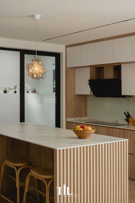 Wooden fluted panels of the kitchen island highlights refined detailing against the white and neutral cabinetry, presenting a clean and timeless appearance. #ApartmentTherapy #ArchitecturalDigest #Dwell #InteriorDesign #InteriorInspo #HomeDecor #HomeInspo #Kitchen #KitchenInspo #Houzz #TheInteriorLab Kitchen Island Panels, Clean Kitchen Design, Japandi Kitchen, Connected To Nature, Japandi Interior Design, Japandi Interior, Neutral Colours, Kitchen Photos, Commercial Interior Design