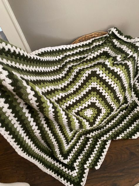 #green #crochet #blanket #handmade Green Black And White Crochet Blanket, Blue And Green Granny Square Blanket, Crochet Green And White, Green Granny Square Crochet, Green And Black Crochet Blanket, Granny Square Crochet Blanket Aesthetic, Green And Brown Crochet Blanket, One Big Granny Square Blanket, Dark Green Crochet Blanket