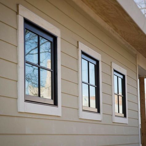 White Trim Tan House Black Windows Exterior, Tan House With Black Windows, Tan House Black Windows, Tan Farmhouse Exterior, Tan House Black Trim, Black Windows Exterior Color Schemes, House Trim Exterior, Outdoor Window Trim, Exterior Cabin