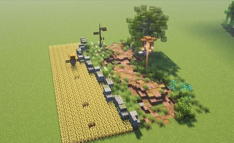 A dirt path following alongside a wheat field with a cobbled stone wall around it and a scarecrow inside. A signpost, lamp and tree decorate the other side of the path as well as smaller details including flower patches, hedgrows and stones. Minecraft Roof, Minecraft Kingdom, Minecraft Structures, Minecraft Blocks, Bangunan Minecraft, Minecraft Farm, Minecraft Cottage, Minecraft Medieval, Path Design