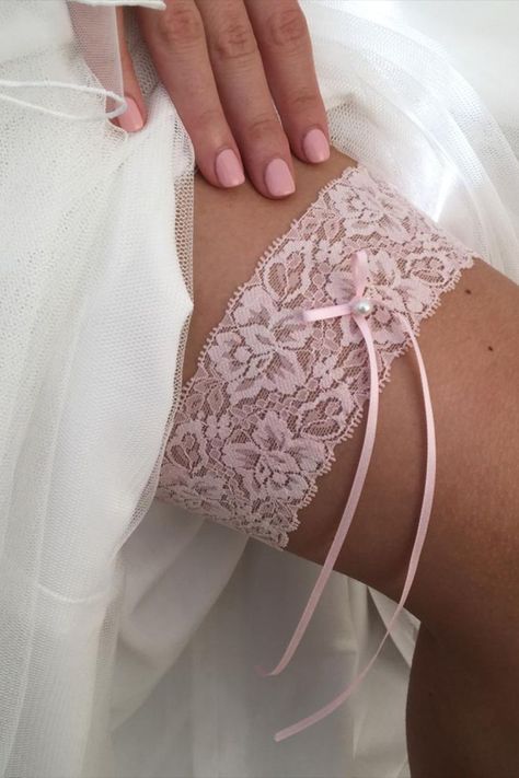 Our Purity wedding garter is perfect for the understated bride. A simple lace garter handmade from a single layer of delicate pale pink lace, finished with a narrow satin ribbon bow adorned with a single ivory pearl. A gorgeous wedding gift for the classic bride, you can't go wrong with this pretty design! Wedding Lengire, Lace Wedding Garter, Bride Garter, Wedding Garter Lace, Pearl Hair Vine, Classic Bride, Bridal Cover Up, Simple Lace, Bridal Handbags