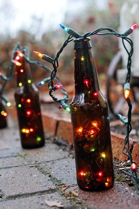 LOVE this idea for an outdoor Christmas light decoration! Lights Decoration Ideas, Beer Bottle Lights, Beer Bottle Decor, Diy Christmas Light Decorations, Beer Bottle Diy, Bottle Upcycle, Beer Crafts, Beer Bottle Crafts, Cool Beer