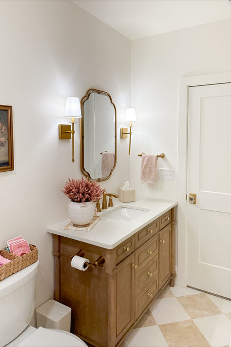 Light and bright guest bathroom with neutral wood tones, creamy whites, and pops of pink! It was important for this space to feel bright and inviting as this space does not have much natural lighting

Spring style, guest bathroom, light and bright, neutral wood tones, creamy whites, pops of pink, gold detail, wall sconce, vanity finds, neutral home, aesthetic finds, gold mirror, Wayfair, Michael’s, found it on Amazon, Target style, bathroom refresh, Grand Millennial Guest Bathroom, Grand Millennial Style Bathroom, Timeless Neutral Bathroom, Pink And Wood Bathroom, Bathroom With Gold Hardware, Nancy Meyers Bathroom, Pink White Bathroom, Kids/guest Bathroom, Bathroom Reno Ideas