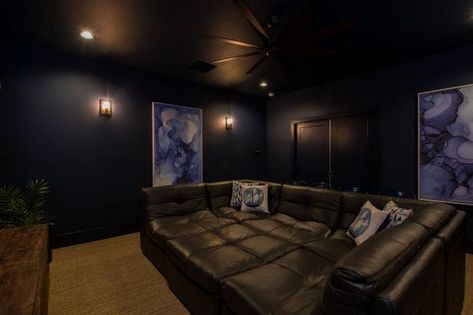 Check out this home theater with dark walls and a leather sectional on HGTV.com. Navy Theater Room, Dark Home Cinema Room, Dark Blue Theater Room, Navy Blue Theater Room, Dark Moody Theatre Room, Navy Blue Movie Room, Dark Home Theatre Room, Dark Blue Movie Room, Dark Blue Media Room