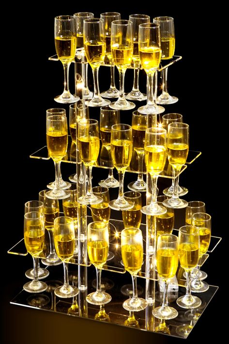 PRICES MAY VARY. Premium Acrylic Material: The HeiMma champagne tower stand is made of high quality acrylic material. The size is 26x20x12 inch, has 32 notched slots to accommodate stemware vertically. Each acrylic panel has protective film on both sides to prevent surface scratches. Please peel off them, and then you will get a crystal clear champagne tower stand Floating Display: The high quality acrylic has a high light transmittance, bright and aesthetic, will give people the illusion of win Floral Champagne Tower, Champagne Ice Mold, Champagne Centerpieces, Champagne Party Decorations, Cocktail Night Decor, Champagne Ideas, Champagne Display, Stemware Rack, Tower Stand