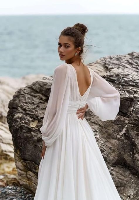 This boho style, long and flowy dress captures the perfect garden/outdoor bride essence. It's also a classy take with the chiffon material and minimal lace detailing that it fits a modern bride asthetic. 
#weddingdress #weddinggown #bridaltrain #bohowedding #outdoors #laceydetail #lowneckline Off The Shoulder Boat Neck Wedding Dress, Loose Long Sleeve Wedding Dress, Flowy Sleeve Wedding Dress, Split Wedding Dress, Court Train Wedding Dress, Floor Length Wedding Dress, Beach Bridal Gown, Boho Bridal Gowns, Wedding Dress Flowy