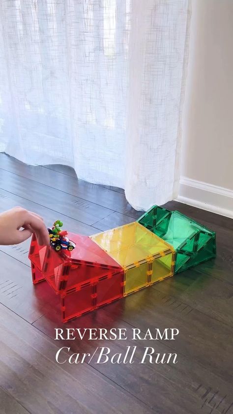 Switch things up with this reverse ramp design! @pandamommyteacher showcases that you don’t need a large Connetix Tile collection to have epic STEAM fun! To make this reverse ramp you need: ⭐ 3 big squares ⭐ 12 small squares ⭐ 4 isosceles triangles ⭐ 6 equilateral triangles Some top tips from Alice-  1. Build the back side first and close the back for support during building. Once you are done building, remove the two bottom pieces on the back to allow the cars/balls to come out. 2. Use light Magnetic Building Toys, Magnet Activities, Magnetic Building Tiles, Ramp Design, Kids Activities At Home, Tiles Ideas, Magnetic Tiles, Daycare Activities, Toddler Play