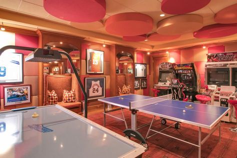 This game room boasts multiple arcade games and a table tennis set surrounded by stylish walls that match the ceiling. Luxury Game Room, Game Room Kids, Retro Games Room, Home Game Room, Arcade Room, Game Room Basement, Recreational Room, Arcade Game Room, Video Game Rooms