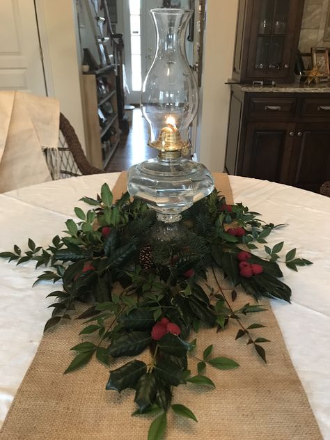 Oil lamp, fresh greenery Oil Lamps On Mantel, Antique Oil Lamps Victorian, Oil Lamp Christmas Decor, Antique Oil Lamp Decor Ideas, Oil Lamp Centerpiece Wedding, Oil Lamp Decor Ideas, Lamp Centerpieces, Oil Lamp Decor, Oil Lamp Centerpiece