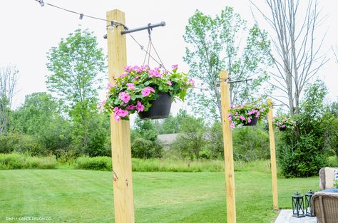 Add Outdoor String Lights on DIY Posts for a beautiful entertaining space and convenient outdoor lighting. Easy weekend project! Outdoor String Lights, Diy Posts, Backyard Lighting, Outdoor Diy Projects, Rustic Outdoor, Patio Lighting, Backyard Projects, Backyard Fun, String Lights Outdoor