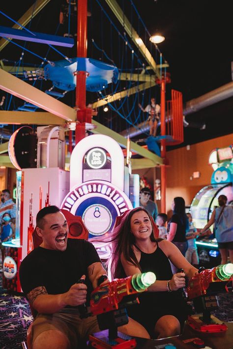 This couple wanted some fun and unique couples photos for their anniversary. So we headed to an arcade so they could have fun and play some games! The carnival lights made for such a cool atmosphere! Arcade Games Photoshoot, Video Game Engagement Photos, Carnival Pics With Boyfriend, Arcade Prewedding, Unique Prenup Photoshoot Ideas, Couples Arcade, Arcade Couple Pictures, Urban Prewedding, Arcade Engagement Photos