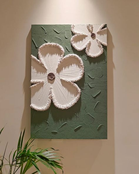 Each piece in the series is crafted on a cotton and linen canvas using acrylic paints to create textured, three-dimensional floral designs that pop against their backgrounds. 🔍 Product: Milly Flowers 3D Wall Art 👆 Tap the link in bio for more wall art pieces! . . . . . . . . . . . . . . . . . . #decorcrushing #interior4u #interior4inspo #sassyhomestyle #inspireushomedecor #housedecoration #mywestwingstyle #moderninteriordesign #dailydecordose #chicinteriors #homedesigns #lightingdesign #drea... White Cement Painting On Canvas, Clay Art For Wall Decor, Cement Art On Canvas, Mini Textured Canvas Art, Canvases On Wall, Canvas Painting With Clay, Clay On Canvas Art, How To Texture Paint On Canvas, Clay Canvas Art