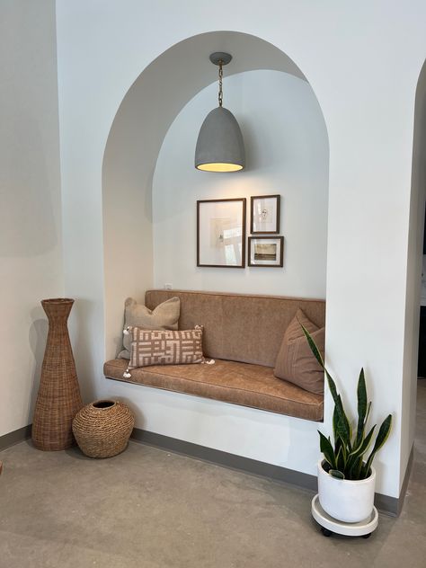 So in love with this special detail from a recent design install. We created an arched sitting nook for our clients to enjoym complementing it with a modern, warm light fixture + greenery and baskets for added coziness & texture!  #interiordesign #boho #moderndesign #neutralhome #arch #archeddoorway #gallerywall #plantaesthetic #neutralaesthetic #cozyaesthetic #cozyhome #fall #falldecor #fallaesthetic Arch Reading Nook, Living Room Arches, Arched Reading Nook, Bangalore House, Wall Nook, Dining Room Sofa, Sitting Nook, Interior Design Classes, Esthetician Room Decor