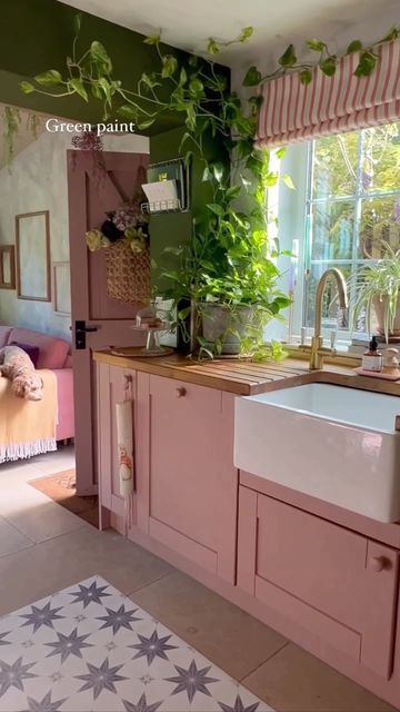 Kathie~The Fairytale Cottage on Instagram: "Most asked questions- answered ~ Boiling water tap @qettle.tap Belfast sink /kitchen @howdensjoinery Pink paint~ link in bio @frenchicpaint Dusky Blush Green paint @lick green 05 Shelves ~ home made-recycled elm boards SAVE this post NOW for reference ~ we will soon be packing up the cottage and moving onto a whole new colour way 🎀🌱 ___ #kitchentips #apartmenttherapy #storyofmyhome #reelofthedąy #biophilia #biophilicdesign #pinkpinkpink" Pink Kitchen Cottage, Pink And Green Cabinets, Green Kitchen With Pink Accents, Pink Eclectic Kitchen, Pink Cabnits Kitchen, Cottagecore Pink Kitchen, Kitchen Pink Decoration, Pink Green And White Kitchen, Colourful Cottage Kitchen