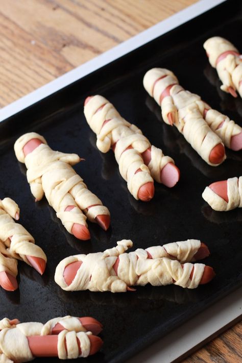 Halloween treats. Mummy dog appetizers. Feet Loaf For Halloween, Halloween Hotdogs Ideas, Halloween Supper Ideas For Kids, Halloween At Home Ideas For Kids, Heloween Decoration Food, Halloween Dinner Kids, Mummy Hotdogs Crescent Rolls, Easy Halloween Recipes For Kids, Lunch Halloween For Kids