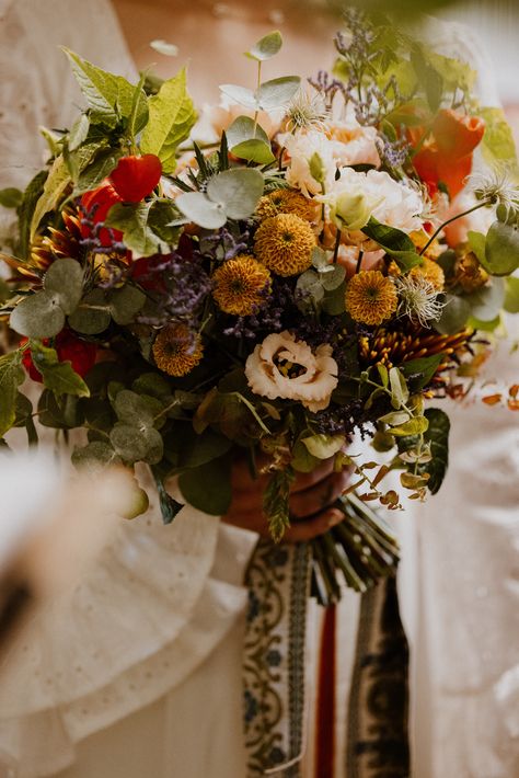 Colourful orange and yellow wedding bouquet with foliage decorated with patterned ribbon for vinatge 70s inspired wedding | wedding flowers | bridal bouquet | The Portfolio People Green And Mustard Wedding, Earthy Bouquet, Velvet Queen Sunflower, 70s Inspired Wedding, Mustard Wedding, Yellow Wedding Bouquet, 70s Wedding, Wedding Bouquet Preservation, Summer Wedding Bouquets