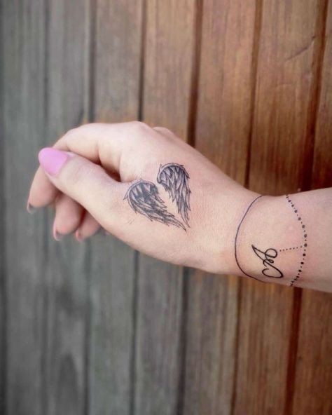 Angel Wings Heart Symbol Small Solid Tattoo, Angel Wing Hand Tattoo, Angel Wings Tattoo For Women, Angel Wing Tattoo On Hand, Wings Tatoos Woman, Fingerprint Angel Wing Tattoo, Angel Wings Memorial Tattoo, Angel Halo Tattoo Ideas, Wing Hand Tattoo