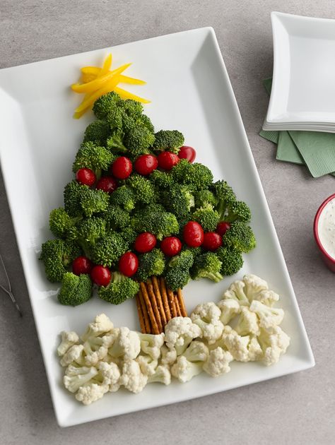 A broccoli and tomato "tree" with a pretzel "trunk" and cauliflower "snow" makes for a memorable and easy Christmas appetizer!