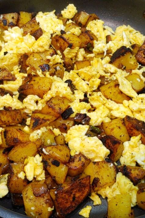 Spicy Potatoes and Scrambled Eggs | "Really good and flavorful...this is a nice change from regular scrambled eggs. I pan-fried the potatoes added tomatoes and doubled the spices for delicious scrambled eggs!" #breakfastrecipes #brunchrecipes #breakfastideas #brunchideas Fried Eggs And Potatoes, Potato Egg Bacon Scramble, Fried Potatoes And Eggs Breakfast, Potato’s And Eggs, Deep Fried Scrambled Eggs, Potatoes With Eggs Breakfast, Fried Potatoes With Eggs, Potato And Egg Scramble, Potato With Egg Recipes