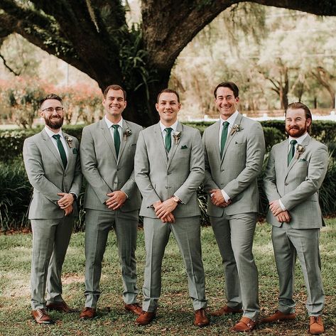 Groomsmen Fashion Inspiration 💚 Venue: @mossestatesvenue⁠ Photography: @monicagracephotography⁠ ⁠ For more Central Florida wedding inspiration follow @WhiteRabbitEventPlanning⁠ ⁠ #whiterabbiteventplanning⁠ #orlandoweddingvenues #barnweddingvenue #weddingphotographer #loveisinthedetails #groomfashioninspiration #groomsmenfashion #boutonniere #dayweddings Grey Green Suit Men, Gray Suits For Men Wedding Green Tie, Grey Green Tuxedo Wedding, Groomsmen Grey Suit Green Tie, Sage Green Tuxedo Wedding Groomsmen, Sage Green And Grey Groomsmen, Grey And Green Suit Men, Gray And Green Groomsmen, Safe Green Groomsmen