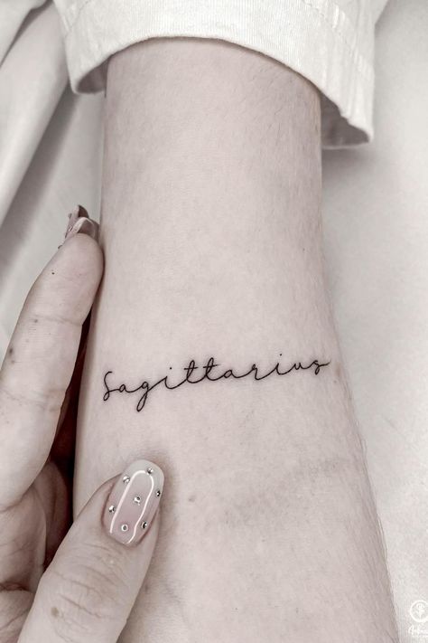 Sagittarius Writing Tattoo, Small Sagittarius Tattoo Simple, Red Sagittarius Tattoo, Sagittarius Word Tattoo, Saggitarius Tattoo For Women, Sagittarius Inspired Tattoos, Simple Sagittarius Tattoo Designs, Small Saggitarius Tattoos, Sagitarius Tattoo Designs