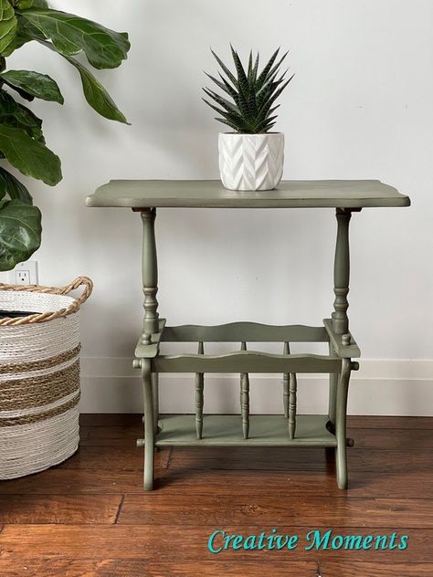 I took a well loved vintage accent table and gave it a brand new fresh look in a rustic green finish. Let me share how. This piece is solid wood on all but the top which is wood veneer top and bottom over a wood frame. All the pieces connect with screws that have a wood knob making it very easy to take apart if needed as well as easy to tighten. The table was scrubbed thoroughly with Painted Table Legs Green, Olive Green Side Table, Farmhouse End Table Green, Green Accent Table, Green Marble End Table, Diy Floating Desk, Antigue Tabletop Plant Stand, Fabric Storage Boxes, Diy Halloween Wreath