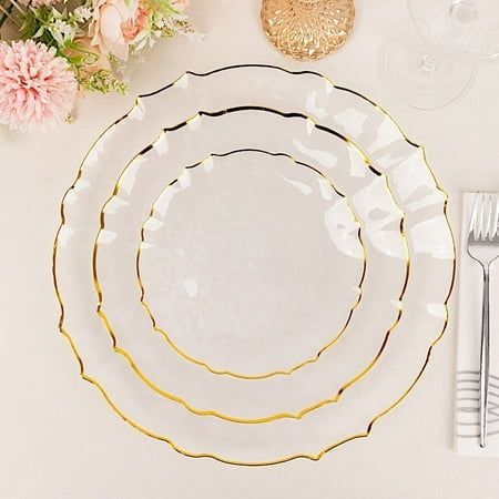 Entertainment just got easier. Serve your guests using these practical yet stylish plates, and let your great food speak for itself! High-quality plastic plates with gold, scalloped edges will make any dinner or lunch look extraordinary. Perfect choice for fine dining occasions where fast cleanup is a must! Use these round plastic plates for weddings, bridal showers, baby showers, birthday parties, or any special events. WHAT YOU GET: Each order is for ten (10) plates. Measurements: Width: appro Clear Plates Table, Plastic Plates For Parties, Wedding Table Settings Elegant Plates, Plate Sets Wedding, Plastic Wedding Tables, Wedding Table Settings With White Plate And Gold Silverware, Wedding Plate Setting Gold, White And Gold Round Table Dinner Setting, Modern Wedding Plates