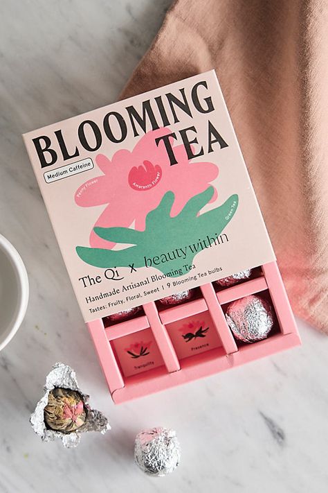 Sweet and fruity, this artisanal blooming tea is made from a harmonious blend of green tea, large peony blooms, and vibrant globe amaranth. Each tea truffle infuses your cup with a symphony of flavors, colors, and aromas. The peony is a sign of abundance and expansion. Together with green tea and amaranth, it’s packed with antioxidants to help fight inflammation, improve brain function, promote heart health and digestive health, and attain balance for that inner and outer glow. Brewing instructi Box Design Creative, Amaranth Flower, Packaging Box Design, Tea Packaging Design, Globe Amaranth, Blooming Tea, Flower Store, Tea Brands, Tea Tasting