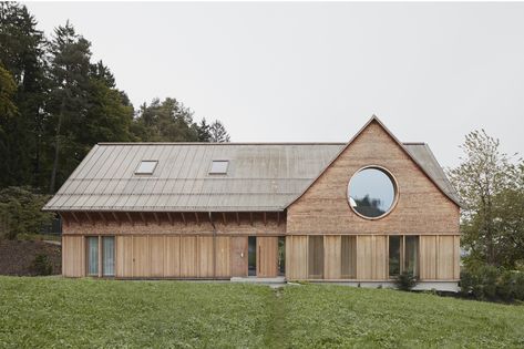 House with Three Eyes / Innauer-Matt Architekten Sandstone Fireplace, Narrow Staircase, Three Eyes, Round Window, Copper Roof, Open Fireplace, Forest House, Architectural Digest, Contemporary Architecture