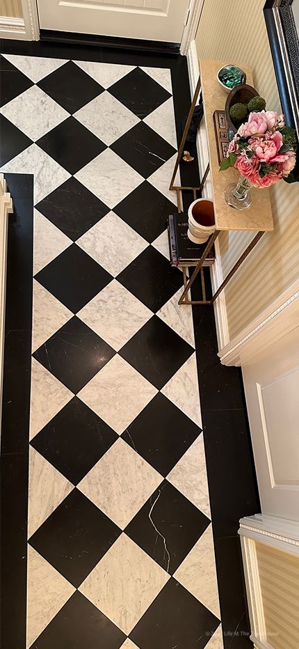 The Harlequin marble floor patern in the foyer. Carrara marble from Italy and Negro Marquina from Spain is used in this floor design. The marble border is 6" wide Negro Marquina. Also, this pattern is not called Checkerboard flooring, but Harlequin. A lot of people call this pattern Checkboard flooring but that is incorrect . Black And Beige Checkered Floor, Honed Marble Checkerboard Floor, Marble And Wood Checkered Floor, Harlequin Pattern Floor, Black And White Marble Checkered Floor Bathroom, Black And White Checkered Marble Floor, Harlequin Floors, Marble Border, Checkered Floor