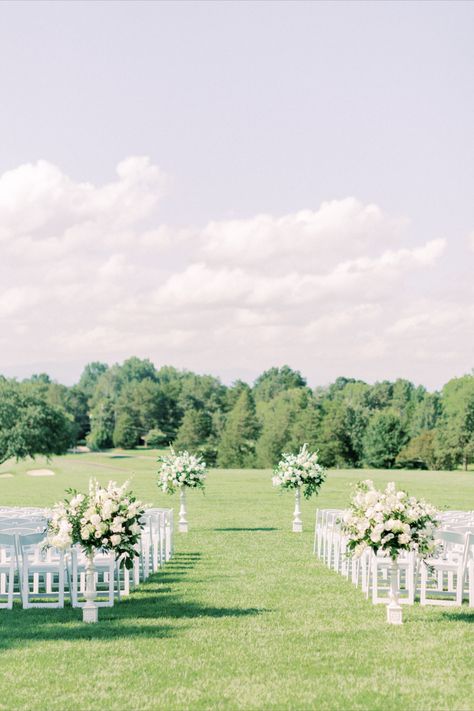 Two small white stanchions mark the beginning of this ceremony aisle, while two larger stanchions will frame the wedding party. Flowers On Ground Wedding Ceremony, Ceremony Florals, Ceremony Aisle, Commitment Ceremony, Wedding Florals, Wedding Floral, White Roses, Wedding Stuff, The Beginning