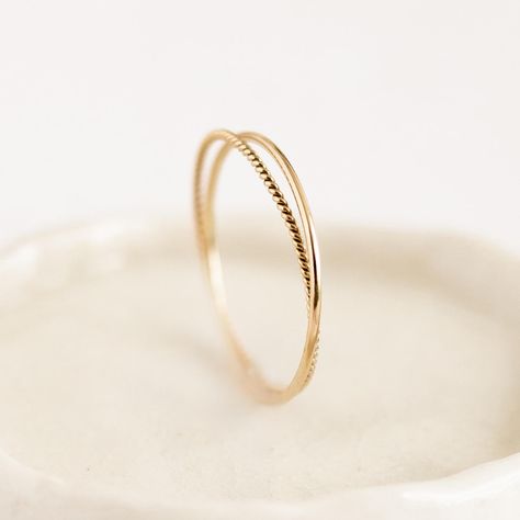 Two intertwined gold rings: a delicate braided band with a simple round-profile band. Double the fun! Simple Promise Rings Gold, Braided Gold Wedding Band, Small Gold Rings, Simple Gold Rings Everyday, Cute Gold Rings, Ring Engraving Ideas, Dainty Wedding Rings, Wedding Bands Simple, Simple Gold Rings