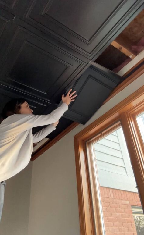 Melissa Tyler popping in a cut tile into her basement drop ceiling. How To Change Drop Ceilings, Basement False Ceiling Ideas, Tiled Basement Floor Ideas, Basement With Black Ceiling Tiles, Low Drop Ceiling Basement Ideas, Dropdown Ceiling Ideas, Best Lighting For Basement, 7ft Basement Ceiling Ideas, Converted Basement Ideas