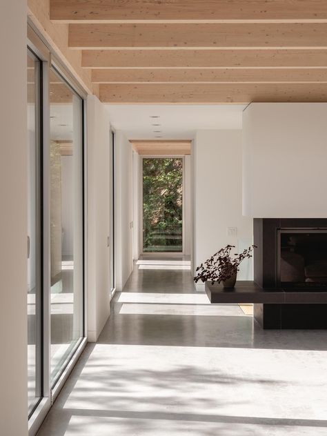 Black Fireplace Surround, Eastern White Cedar, Warm Minimalism, Rocky Landscape, Cabin Aesthetic, Tall Windows, Minimal Furniture, Cedar Siding, Forest House