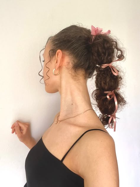 Pink ribbon bubble braid on curly hair Curly Hair Bows Hairstyles, Hair Bows Curly Hair, Bows Curly Hair, Curly Ribbon Hairstyles, Bows In Curly Hair, Bow Curly Hairstyle, Curly Hair With Bow Hairstyles, Bow In Curly Hair, Bow Hairstyle Curly Hair