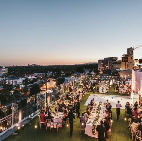 This classic rooftop wedding at the London Hotel was perfect for this beautiful Los Angeles night. The hotel provided a gorgeous view of the cityscape while maintaining an intimate feel. Lush runners of greenery and blooms cascaded over the ends of the longer tables. Elegant furniture and decor displayed accents of gold and navy.  www.bestbride.la https://www.instagram.com/bestbride_/ http://www.bestbride.la/galleries/candace-scott/ #wedding #white #rooftop #photography #navy #gold Wedding Ideas Rooftop, Rooftop Reception Decor, Rooftop Terrace Wedding Decor, Rooftop Party Decorations Night, Rooftop Graduation Party, Rooftop Event Decor, Rooftop Bar Wedding, Roof Top Wedding Decor, Rooftop Wedding Reception Decor