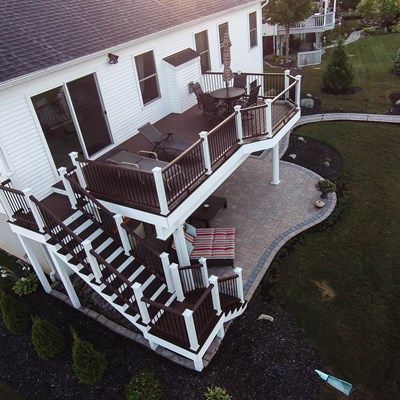 One of the challenges we come across often as we design walkout elevated decks is the column/post placement. It’s never appealing to have a window or door looking out at a column. This deck would typically have a minimum of 3 posts, but since we kept the design simple, we were able to make the 20’ span with just 2 posts by upgrading to an engineered beam. The result is an unobstructed view from the walk-out basement.  With a purposely simple design, it’s the details and finishes that bring t... Patio Under Decks, Deck Remodel, Backyard Patio Deck, Deck And Patio, Deck Pictures, Building A Porch, Patio Deck Designs, Cozy Backyard, Deck Designs Backyard