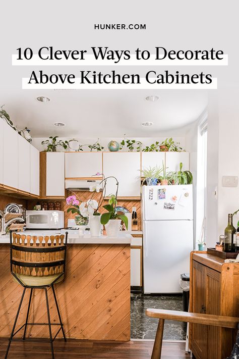 Unless you've been blessed with kitchen storage that extends to the ceiling or a series of open shelves, you've likely pondered at one point or another: "How should I fill that awkward space above my cabinets?" #hunkerhome #kitchen #cabinets #cabinetideas #kitchencabinet Not Enough Kitchen Cabinets, High Ceiling Kitchen Decor, Storage Above Kitchen Cabinets Baskets, Kitchen Cabinets That Do Not Go To Ceiling, Filling Space Above Kitchen Cabinets, Kitchen Cabinets Dont Reach Ceiling, Plants On Cabinets, Fill Space Above Kitchen Cabinets, Wasted Space Above Kitchen Cabinets