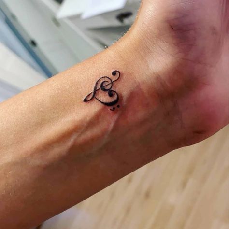 Small Meaningful Tattoos Music, Couple Tattoos Music Notes, Treble Clef Tattoo Finger, Treble Clef With Semi Colon, Treble Clef And Bass Clef Tattoo, Musical Heart Tattoo, Bass And Treble Clef Tattoo, Trombone Tattoo Small, Treble Bass Clef Heart Tattoo