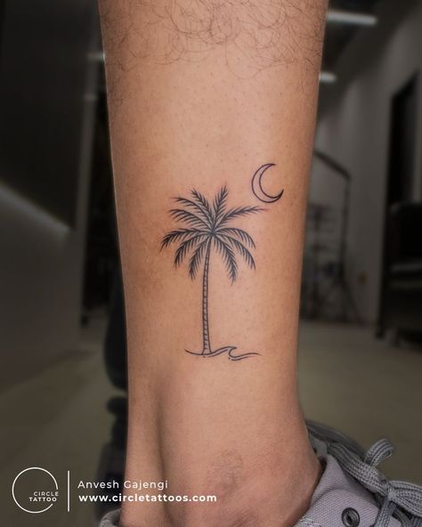 Looking for a permanent reminder of sunny weather, exotic beaches, fruity drinks, and sensational sunsets? These Coconut Tree tattoos are the perfect way to show. #coconuttreetattoo #coconuttreetattoodesign #coconuttreetattoosmall #coconuttreetattooformen #cononuttreetattooforwomen #coconuttreetattooankle Palm Tree With Coconut Tattoo, Ankle Palm Tree Tattoos For Women, Palm Trees Tattoos For Women, 2 Palm Trees Tattoo, Palm Tree Simple Tattoo, Palm Tree And Sunset Tattoo, Coconut Palm Tree Tattoo, Palm Tree Moon Tattoo, Coconut Tree Tattoo Minimalist