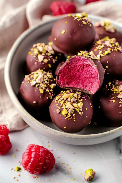 Every bite of these raspberry truffles is rich, creamy, and fruity. You'll love dark chocolate coating and how the vibrant color inside makes them pop. Berry Truffle Dessert Easy, Raspberry Filled Chocolate Bites, Strawberry Chocolate Truffles, Truffle Bites, Chocolate Raspberry Truffles, Dark Chocolate Raspberry Truffles, Raspberry Truffles, Raspberry Truffle, Lemon Truffles