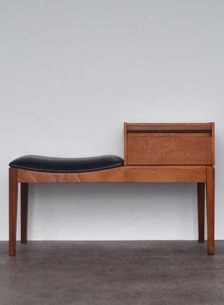 A rare telephone bench constructed of teak with a beautiful teak grain and black leatherette seat. Features a single drawer and a wipe clean shelf. Manufactured by Chippy Heath of High Wycombe, circa 1960's. Great for your hallway and especially for storing keys. Dimensions: Width: 86.0 cm, Height: 55.0 cm, Depth: 38.0 cm. Date of manufacture: 1960s. Period: Mid 20th Century. Materials: Leather, Teak. Brand / Manufacturer: Chippy Heath. Place of origin: Denmark. Telephone Bench, Telephone Seat, Mid Century Bench, High Wycombe, Danish Style, Vintage Telephone, Shoe Bench, Chair Bench, New Vintage