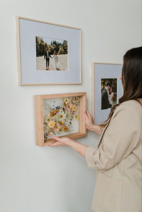 What better way to display your preserved wedding bouquet than next to printed photos from your wedding? Wedding Flower Frame Dried, Wall Of Wedding Photos, How To Display Engagement Pictures, Printed Wedding Photos, Bedroom Wedding Photos, Framed Wedding Flowers, Wedding Photos Framed Wall Display Ideas, Wedding Flowers In Frame, Diy Bouquet Preservation