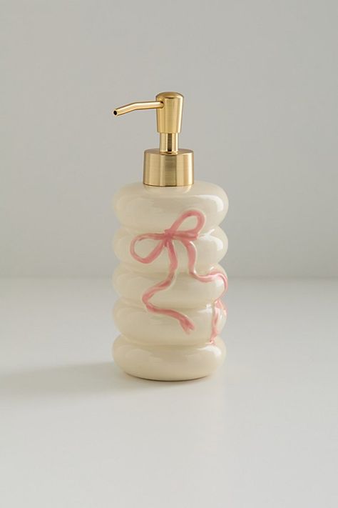 The bow on top of your cleanliness routine, this ceramic soap dispenser features a bubbled silhouette with a sweetly femme bow at the front. Pair it with other favorites from our Bow bathroom collection to create a coordinated set. Available exclusively at Urban Outfitters. Features Bow soap dispenser from UO Home Crafted from ceramic with a bow at the front One-of-a-kind hand-painted variance UO exclusive Content + Care Ceramic Wipe clean Imported Size Dimensions: 3.3" dia x 7.5" h Weight: 0.7 lbs | Bow Soap Dispenser in Rose at Urban Outfitters