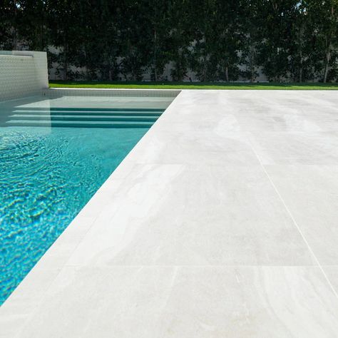 Modern Concrete Pool Deck 2024: 20+ Designs You Will Love 14 Modern Pool Decking, Modern Concrete Pool Deck, Outdoor Pool Tile Ideas, White Limestone Pool Deck, White Pool Decking, Ice White Sandblasted Marble Pool Deck, Pool Area Tiles, Minimalist Pool Designs, Neutral Pool Tile Ideas